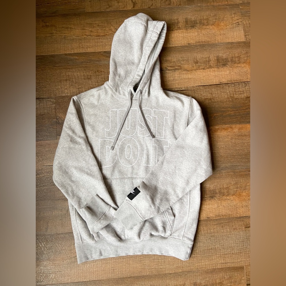Small, light gray Nike hoodie. Soft and warm cotton material